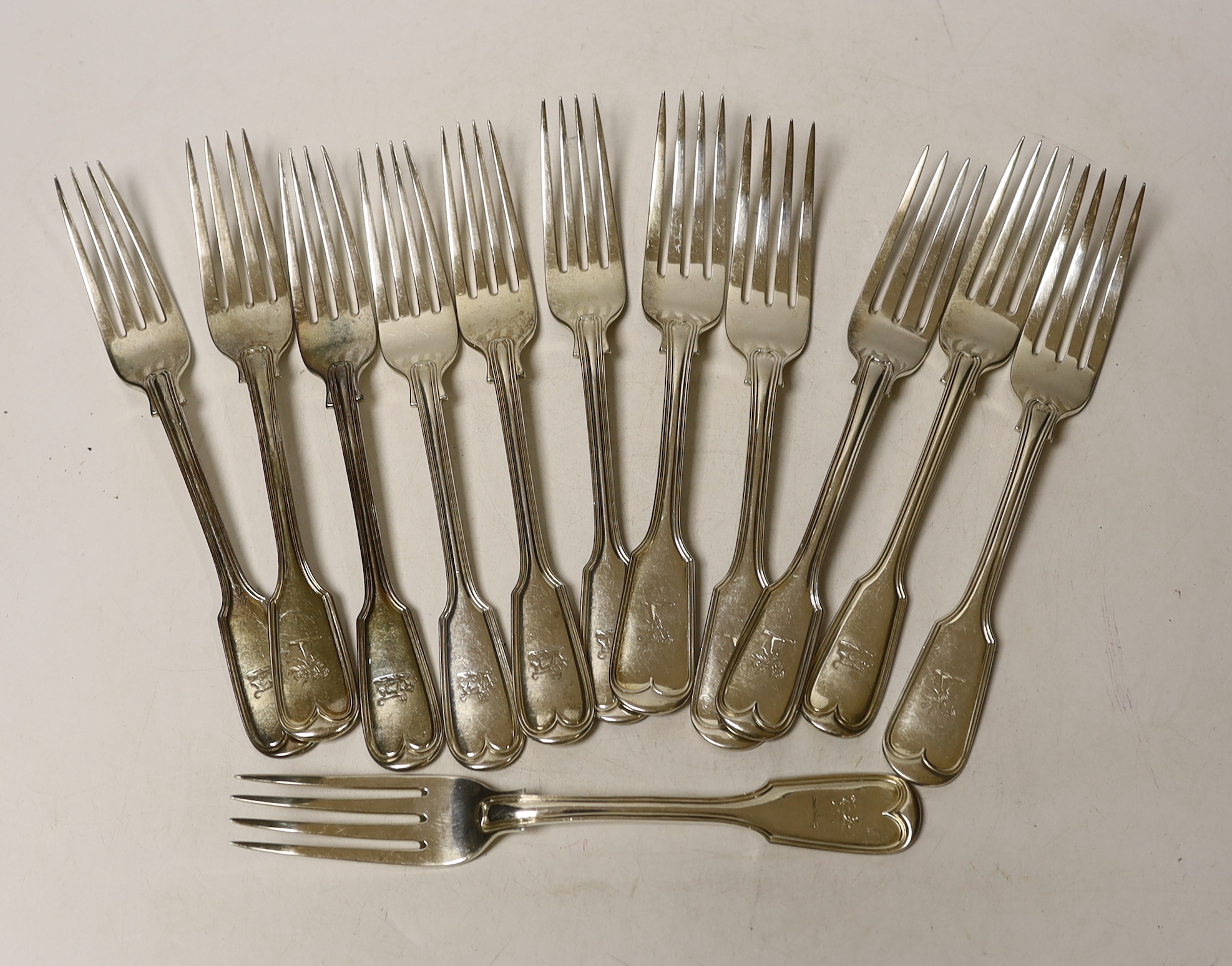 A matched set of twelve 19th century silver fiddle and thread pattern table forks, various dates and makers, including Exeter, some hallmarks very rubbed, 36.1oz.